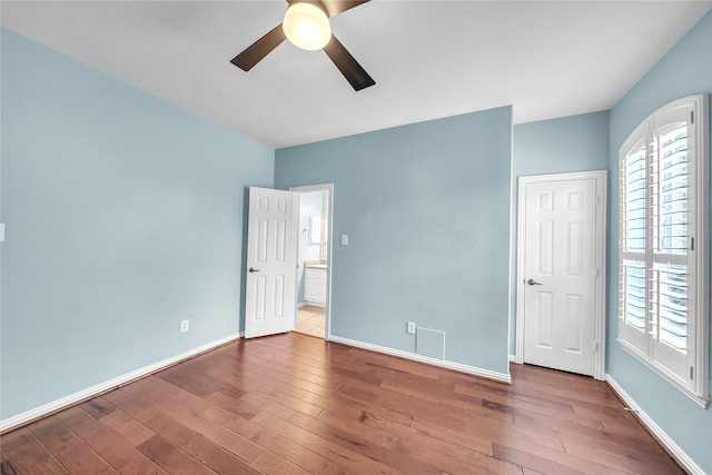 unfurnished bedroom with baseboards, a ceiling fan, and wood finished floors