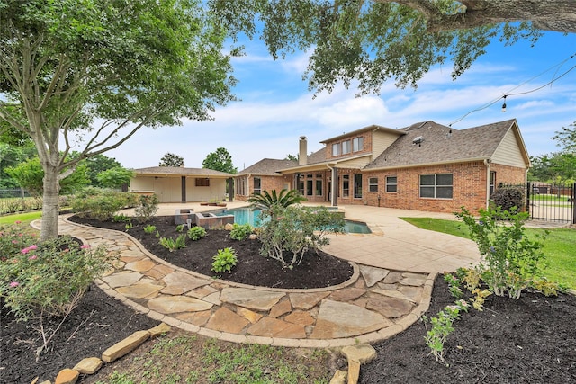 back of house featuring brick siding, a patio area, fence, and a fenced in pool