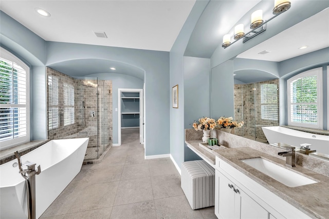 full bath featuring tile patterned floors, a shower stall, a healthy amount of sunlight, and vanity