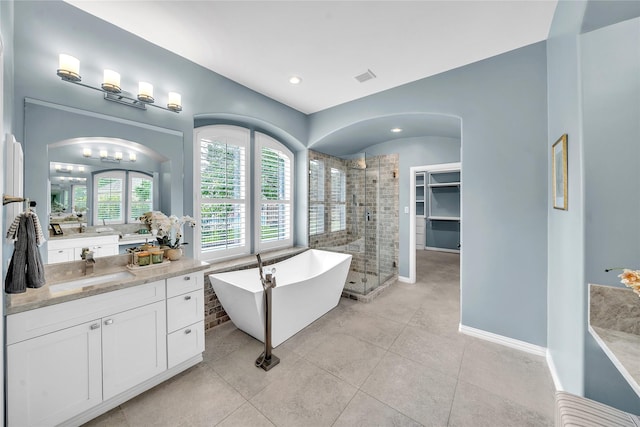 bathroom with visible vents, a freestanding tub, tile patterned flooring, a stall shower, and vanity