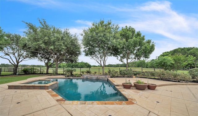 view of pool with a fenced backyard, a patio area, and a pool with connected hot tub