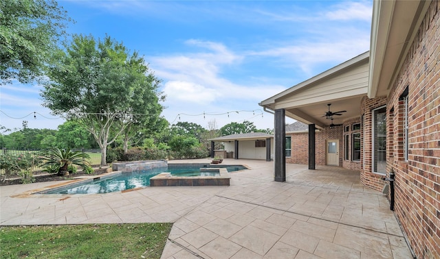 view of pool featuring a ceiling fan, a patio, and a pool with connected hot tub