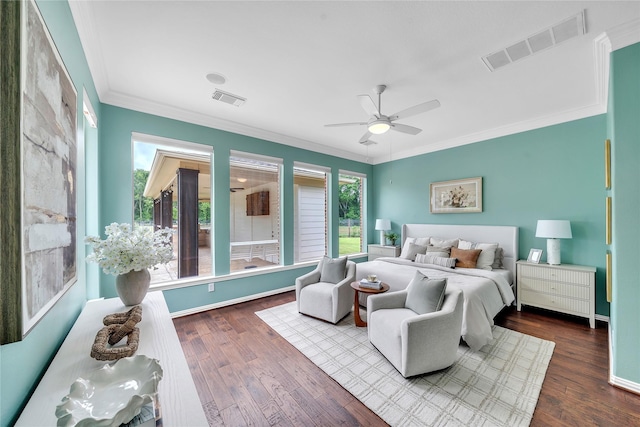 bedroom featuring dark wood-style flooring, visible vents, and ornamental molding