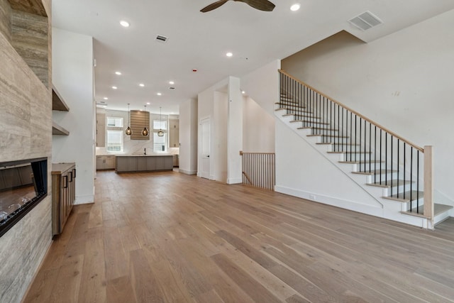 4705 Gibson St, Houston, TX 77007 - unfurnished living room featuring light wood finished floors, a ceiling fan, recessed lighting, stairs, and baseboards