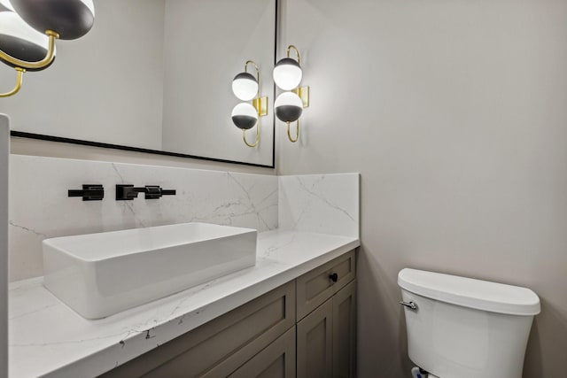 4705 Gibson St, Houston, TX 77007 - half bathroom featuring decorative backsplash, vanity, and toilet