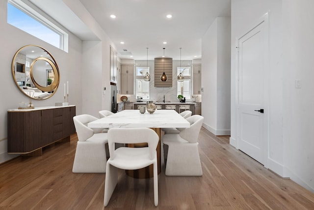 4705 Gibson St, Houston, TX 77007 - dining room featuring light wood-type flooring, recessed lighting, and baseboards