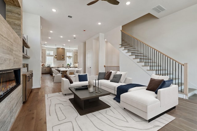 4705 Gibson St, Houston, TX 77007 - living area with light wood finished floors, stairs, a ceiling fan, recessed lighting, and a large fireplace