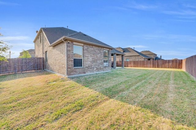 717 Willowbranch Ln, Midlothian, TX 76065 - back of property featuring a shingled roof, brick siding, a fenced backyard, cooling unit, and a lawn