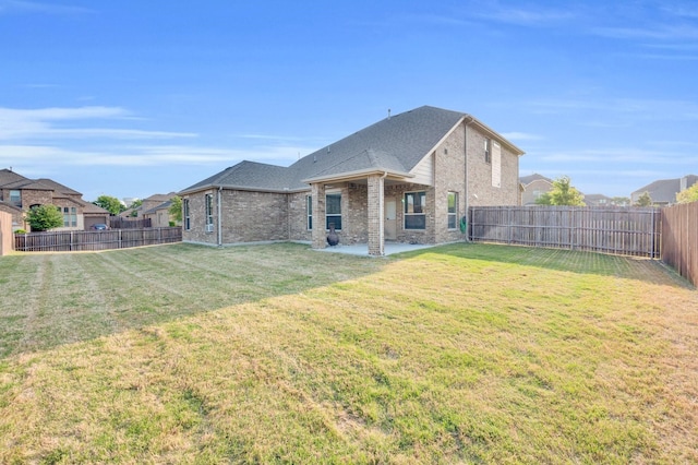 717 Willowbranch Ln, Midlothian, TX 76065 - rear view of house with brick siding, a fenced backyard, a patio area, and a yard