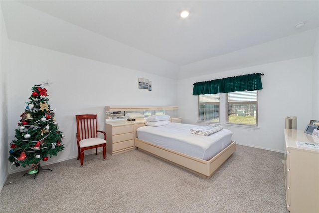 bedroom featuring light carpet and baseboards