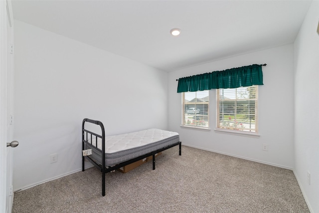 bedroom featuring baseboards and carpet floors