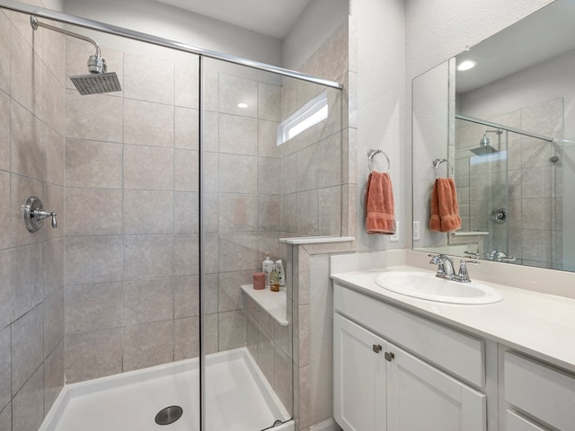 bathroom with vanity and a stall shower