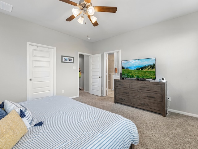 carpeted bedroom featuring visible vents, connected bathroom, baseboards, and ceiling fan