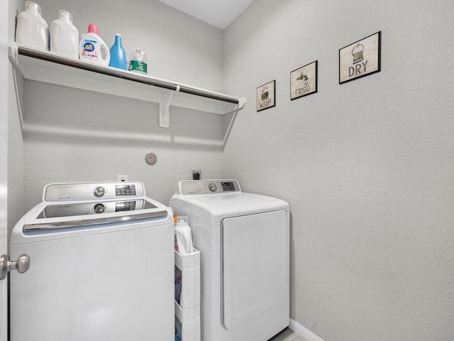laundry area featuring baseboards, laundry area, and washer and clothes dryer
