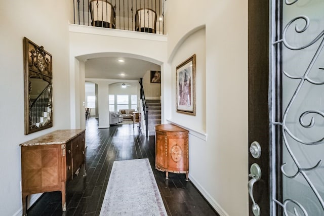 2116 Nogalas Ln, League City, TX 77573 - entrance foyer with dark wood-style floors, baseboards, arched walkways, and stairs
