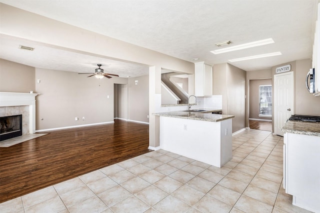 1918 N Everglades Dr, Deer Park, TX 77536 - kitchen featuring visible vents, stainless steel microwave, white cabinets, and a sink