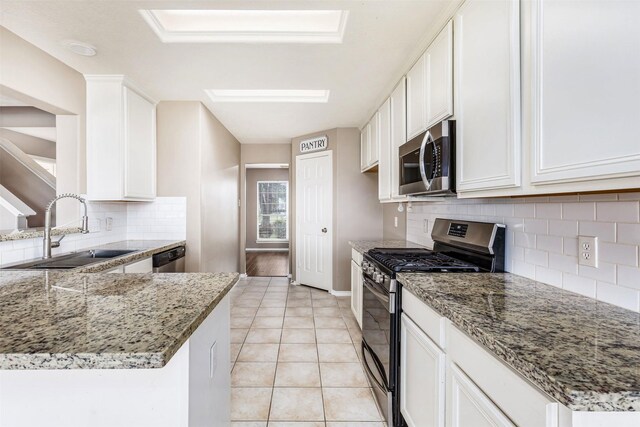 1918 N Everglades Dr, Deer Park, TX 77536 - kitchen featuring light stone counters, appliances with stainless steel finishes, and a sink