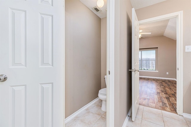 1918 N Everglades Dr, Deer Park, TX 77536 - bathroom featuring tile patterned flooring, toilet, baseboards, visible vents, and lofted ceiling