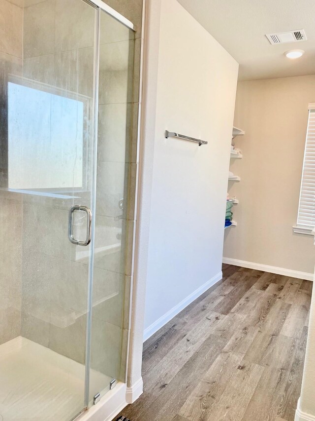 985 Harper Ln, Bryan, TX 77803 - bathroom featuring wood finished floors, a stall shower, baseboards, and recessed lighting
