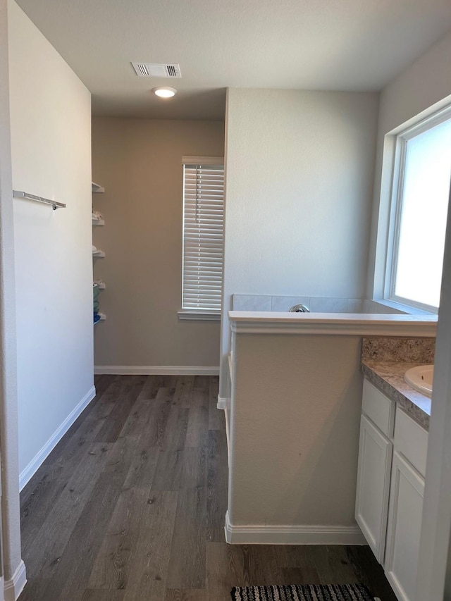 985 Harper Ln, Bryan, TX 77803 - bathroom with wood finished floors, vanity, and baseboards