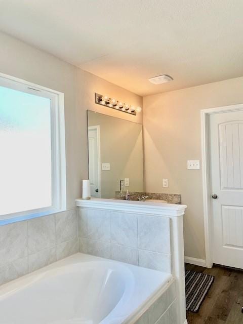 985 Harper Ln, Bryan, TX 77803 - full bath with a bath, wood finished floors, and vanity