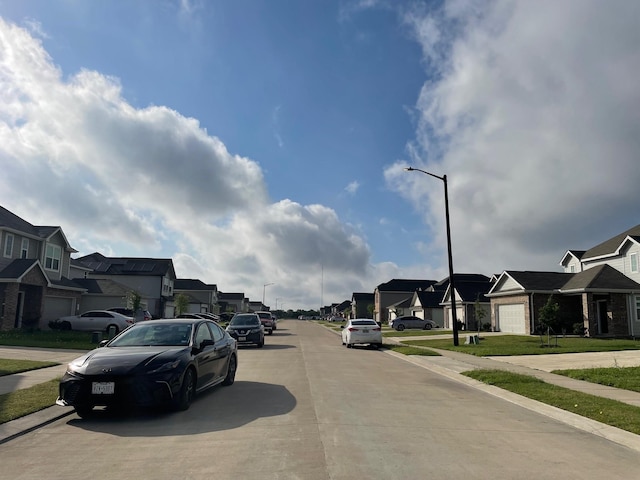985 Harper Ln, Bryan, TX 77803 - view of concrete road featuring a residential view, sidewalks, street lights, and curbs
