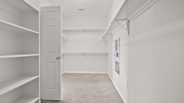 spacious closet with visible vents and carpet flooring