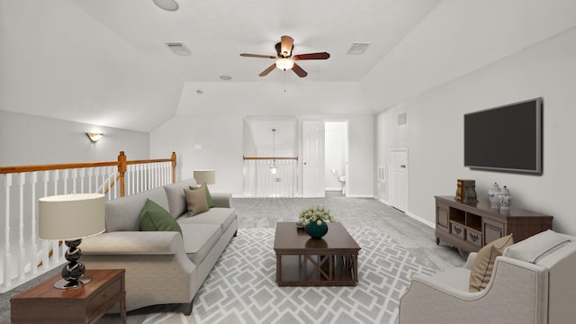 carpeted living room featuring visible vents, ceiling fan, and lofted ceiling