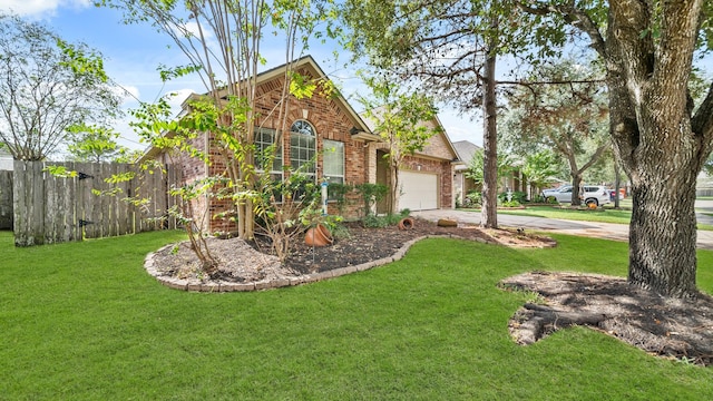 view of front of house with a front yard, brick siding, concrete driveway, an attached garage, and fence