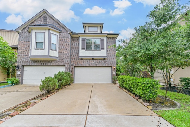 multi unit property with driveway, an attached garage, and brick siding