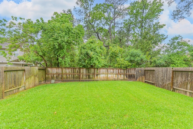view of yard with a fenced backyard