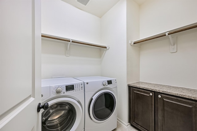 washroom with washer and dryer and visible vents