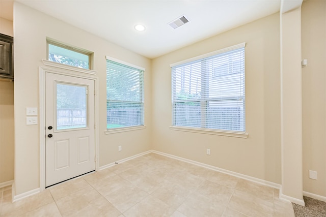 doorway to outside with recessed lighting, visible vents, and baseboards