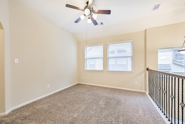 spare room with visible vents, ceiling fan, carpet floors, and baseboards