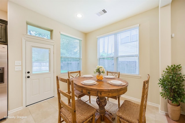 dining room with light tile patterned flooring, visible vents, recessed lighting, and baseboards