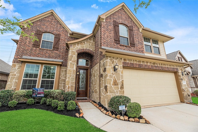 20535 Kohle Springs Ln, Cypress, TX 77433 - traditional home featuring brick siding, driveway, stone siding, a front lawn, and an attached garage