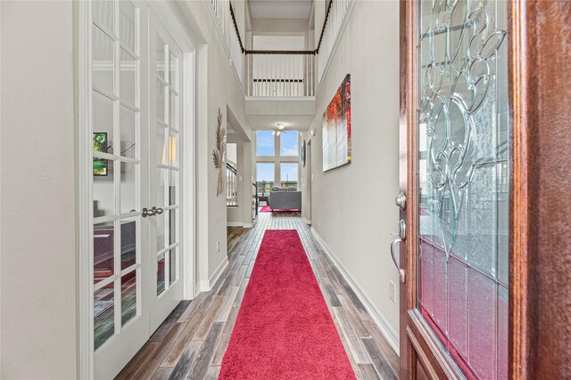 20535 Kohle Springs Ln, Cypress, TX 77433 - hallway with wood finished floors, french doors, a towering ceiling, and baseboards