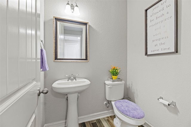20535 Kohle Springs Ln, Cypress, TX 77433 - half bath featuring wood finished floors, toilet, and baseboards