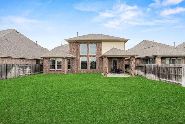 20535 Kohle Springs Ln, Cypress, TX 77433 - back of house with brick siding, a fenced backyard, a yard, and a patio area