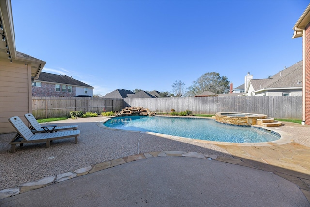 view of pool featuring a pool with connected hot tub, a fenced backyard, and a patio area