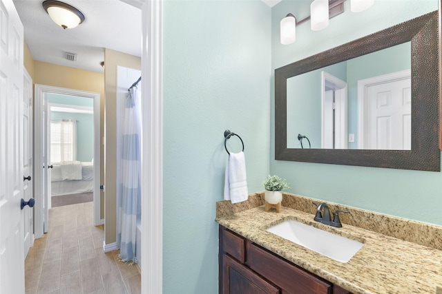 full bath with wood finish floors, visible vents, curtained shower, and vanity