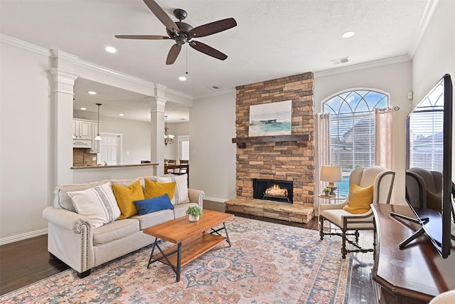 living room featuring baseboards, a ceiling fan, wood finished floors, and visible vents