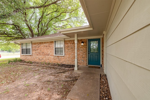 property entrance with brick siding