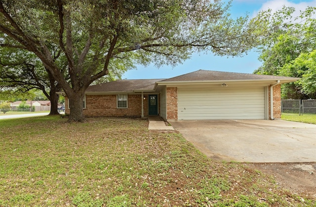 ranch-style home with a garage, brick siding, fence, and driveway