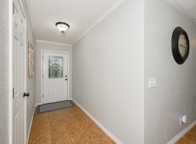 entryway featuring baseboards, light tile patterned floors, and ornamental molding