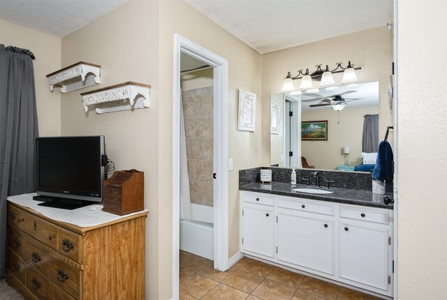 bathroom featuring tile patterned flooring, a ceiling fan, vanity, and shower / washtub combination