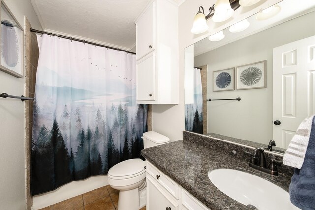 bathroom with curtained shower, vanity, toilet, and tile patterned flooring