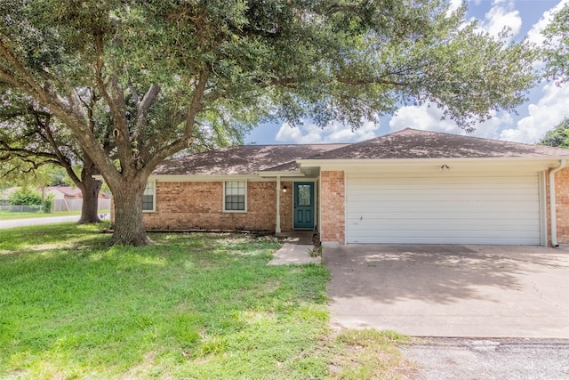 923 N Hull St, Caldwell, TX 77836 - ranch-style home with brick siding, an attached garage, driveway, and a front lawn