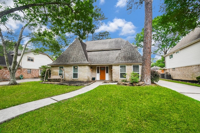 14619 Rosehill Dr, Houston, TX 77070 - view of front of property featuring roof with shingles, a front lawn, brick siding, central AC unit, and concrete driveway