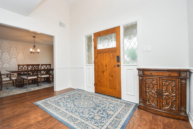 14619 Rosehill Dr, Houston, TX 77070 - entrance foyer with wainscoting, wood finished floors, and a chandelier